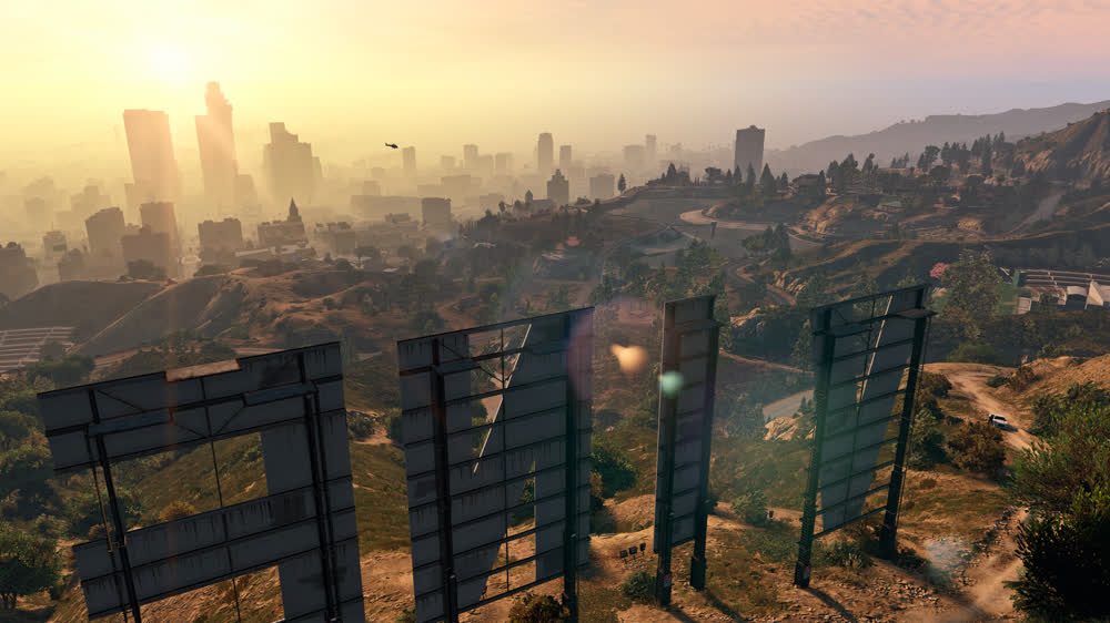 Franklin, Michael i Trevor na tle mapy Los Santos — oficjalna grafika Grand Theft Auto V