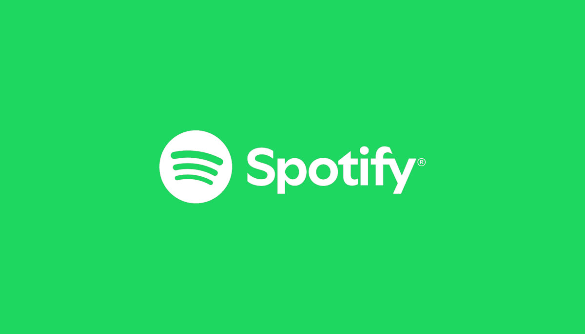 Słuchawki nauszne wśród świecących nut na fioletowo-turkusowym tle z oficjalnych materiałów Spotify